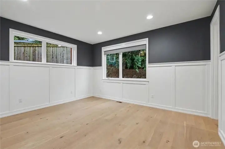 Charming upstairs guest bedroom featuring elegant wainscoting and a spacious walk-in closet for comfort and style.