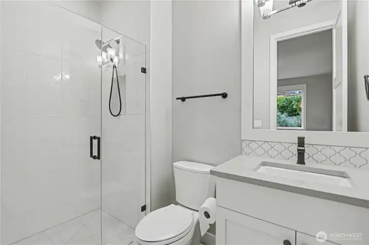 Private ¾ guest bathroom conveniently connected to the bedroom, offering modern finishes and comfort for visitors.