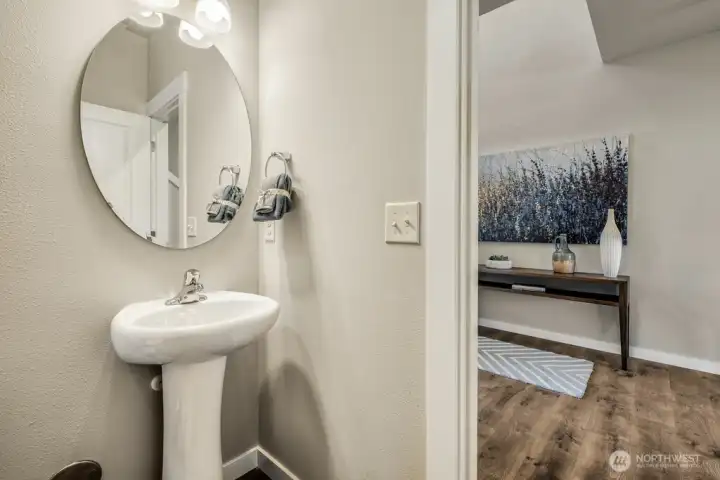 1/2 bath located next to den/ home office. Photos are for representational purposes only.  Colors and finishes may vary.