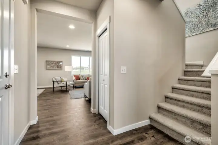 Extended laminate flooring thru entry, family room and kitchen. Low maintenance. Photos are for representational purposes only.  Colors and finishes may vary.