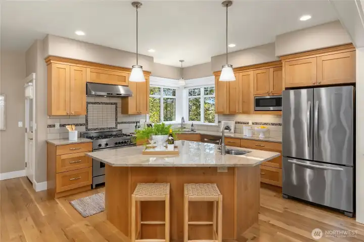 The bright chef's kitchen is well appointed with a Bertazzoni range/oven and extra wide fridge.  A spacious pantry is located to the left.