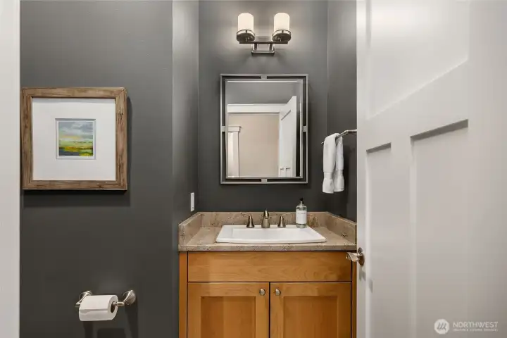 The powder room is conveniently tucked away just around the corner from the main-living area.