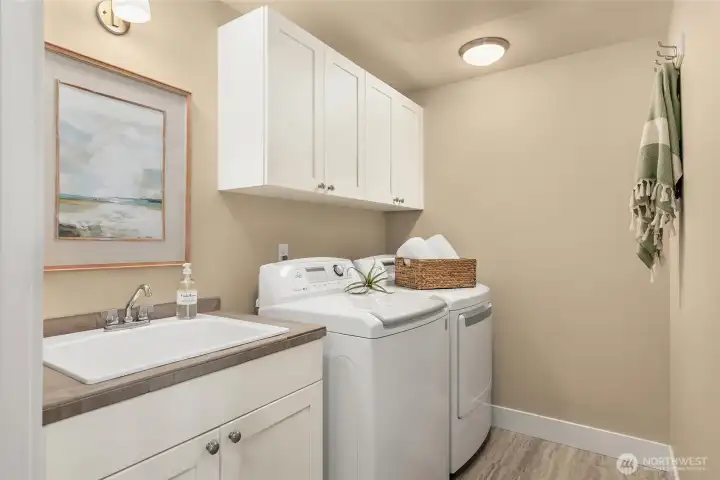 The spacious laundry room offers great storage, a large laundry sink and is across from the powder bath.