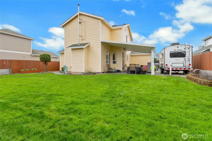 Fully fenced yard with wired RV space and covered patio.