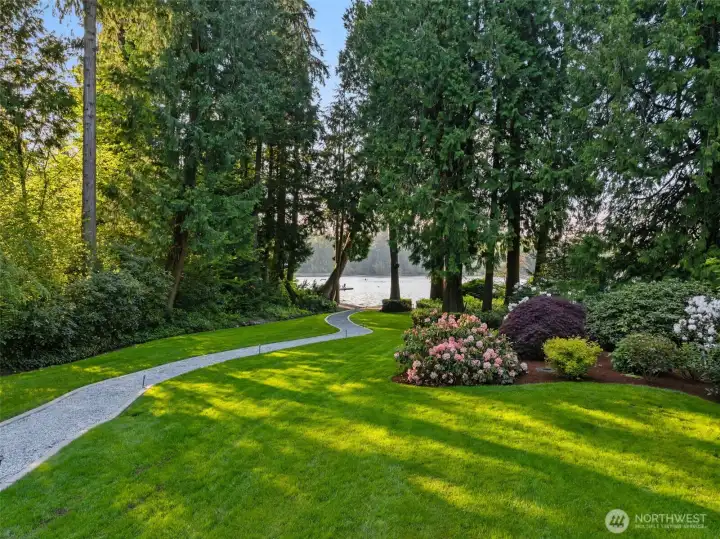 Remarkable privacy on approximately two acres of beautifully landscaped grounds with 147 feet of shoreline, no homes visible across the lake