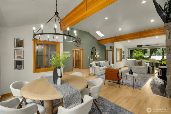 Dining area with refinished hardwood floors, vaulted ceilings, and exposed beams