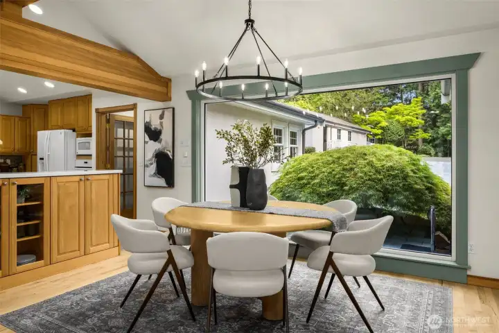 Dining area with refinished hardwood floors, vaulted ceilings, and exposed beams