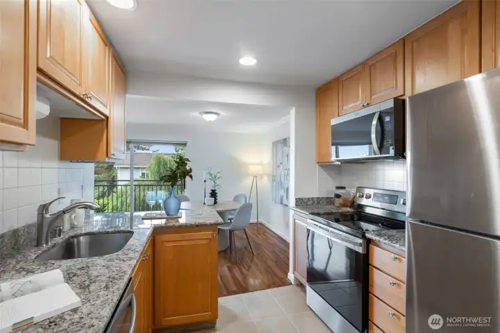 Upgraded kitchen featuring modern appliances and elegant granite countertops.    Key Kitchen Features:  *   Contemporary kitchen layout with ample storage.  *   Newer, high-performance appliances.  *   Durable and stylish granite countertops.  *   Ideal space for cooking, dining, and casual entertaining.  *   Clean, polished aesthetic that complements the home's overall design.