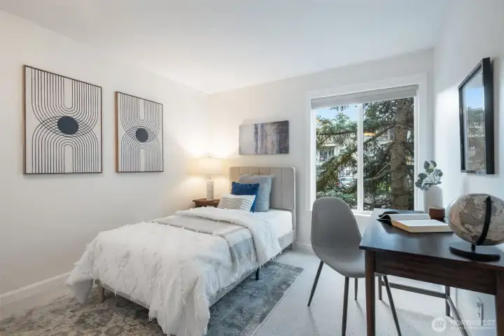 Bright, light-filled room perfect for use as a guest bedroom or home office, featuring a spacious closet