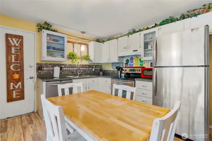 Functional kitchen with plenty of storage. Stainless appliances and tile backsplash create a great working area.