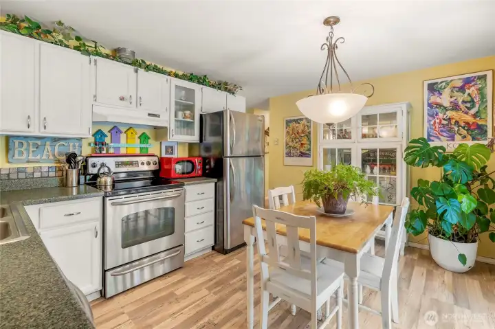 Beautfiul daylight pours in to this working kitchen where people gather
