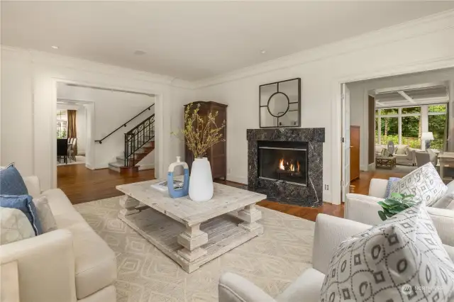The living room is light & airy with marble faced fireplace & hardwood floors.