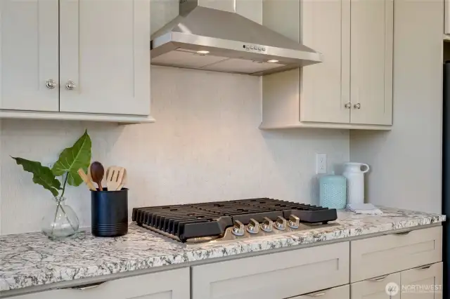 Full height custom tile backsplash and soft close cabinets & drawers.