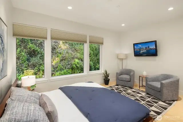 Located on the primary level, this sprawling bedroom has a large closet with build in shelving, private views to rear & adjacent bath.
