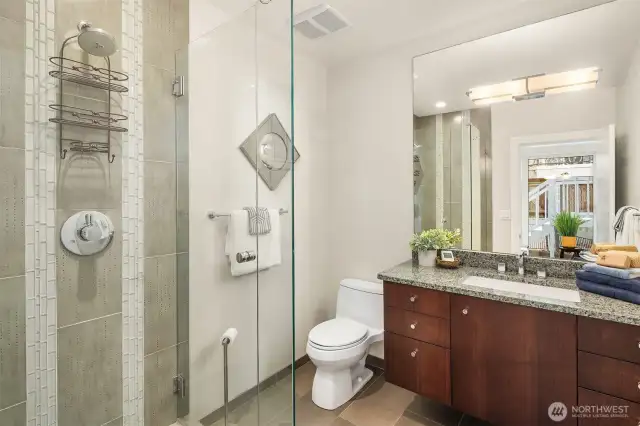 Bath is adjacent to the second bedroom on the primary level.