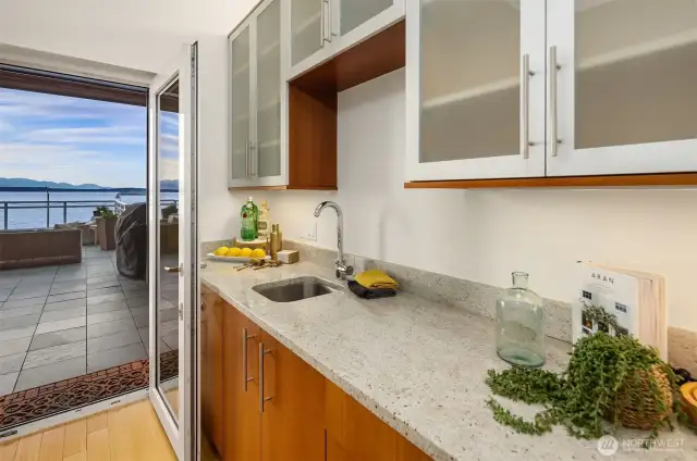 Top floor bar has mirrored rich finishes complementing the kitchen design.
