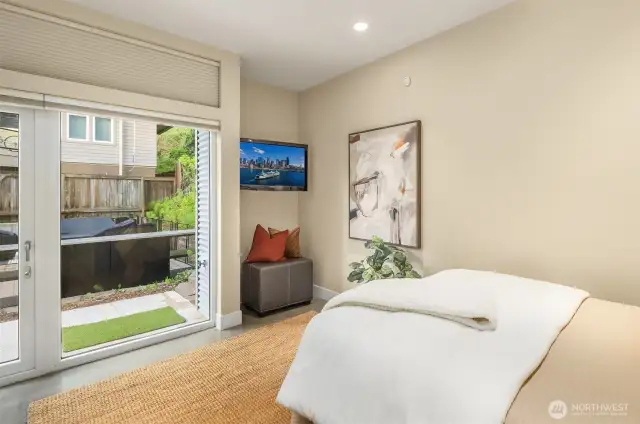 Main level bedroom has polished concrete heated flooring with private door to the side patio.