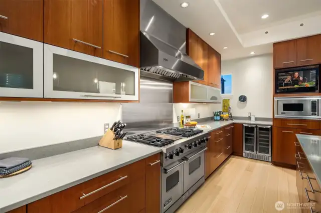 Huge 6-burner PLUS two-burner grill station complemented by double oven Viking range.