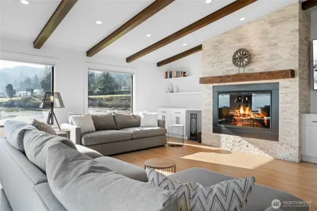 Cozy up to the 52" wood-burning fireplace in the living room, complete with a custom mantel and built-in cabinetry for additional storage.