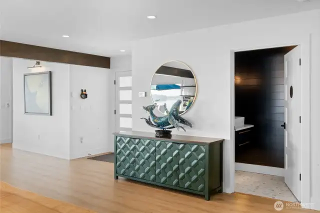 As you enter, you'll find a spacious entry closet as well as a tastefully designed powder room right around the corner.