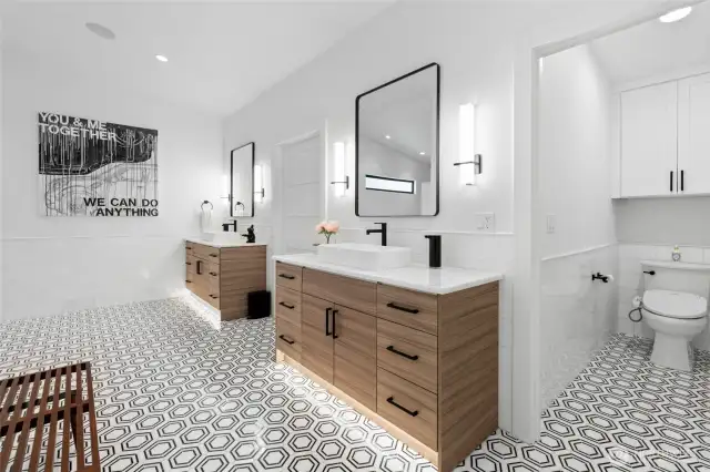 This primary bathroom is what dreams are made of. Oversized double vanities, private water closet, pocket door for separation from the primary bedroom, heated floors, and wait until you see the shower...