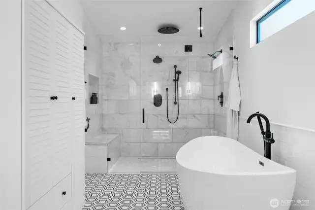 WOW! This shower and tub area is pure luxury. Curbless entry for accessibility as well as a bench, double shower heads and relaxing rain shadow. Is this a spa or your new bathroom?