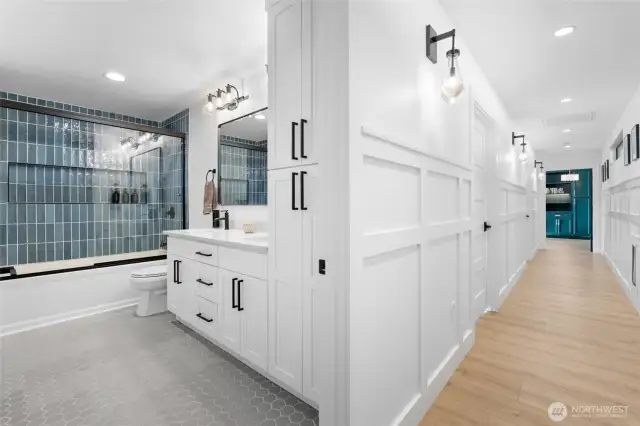 Full hall bath with stylish tile work and heated flooring is on the opposite side of the home from your primary suite for ultimate privacy.