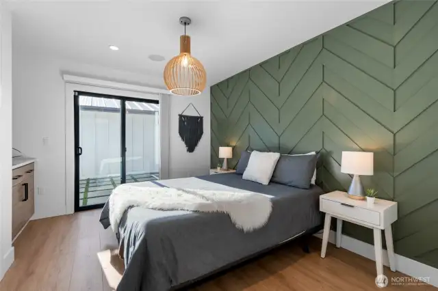 Guest room with custom wall detail, built in shelving as well as large closet, and easy access to the pool.