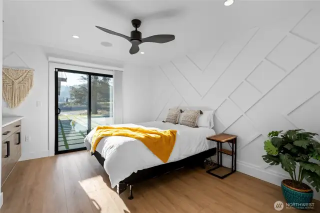 Guest room with custom wall detail, built in shelving as well as large closet, and easy access to the pool.