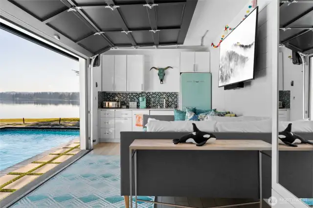 No detail was overlooked throughout this property: playful tile backsplash and the coolest retro fridge you'll ever see.