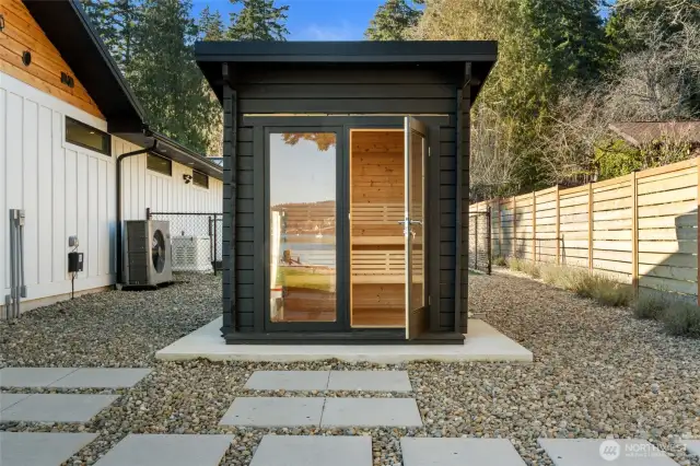 Tucked around the corner for complete privacy is a sunken hot tub and relaxing sauna, complete with a convenient outdoor shower.