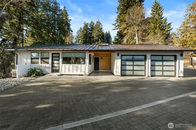 Across the driveway is an additional home, fully renovated and complete with a covered outdoor sitting area and spacious 2-car garage.