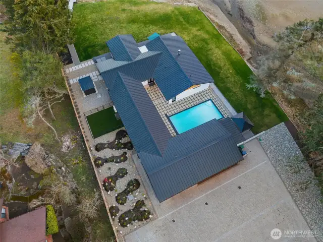 Aerial view showing the thoughtful layout of the home to maximize views, privacy and easy access to the pool as well as the waterfront.