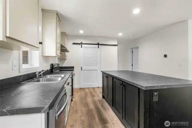 Barn door leads to oversized pantry/utility room