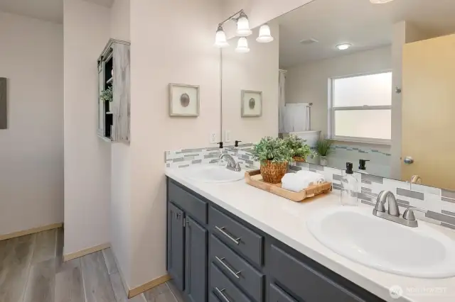 Dual vanities and jetted tub await in the primary bath.