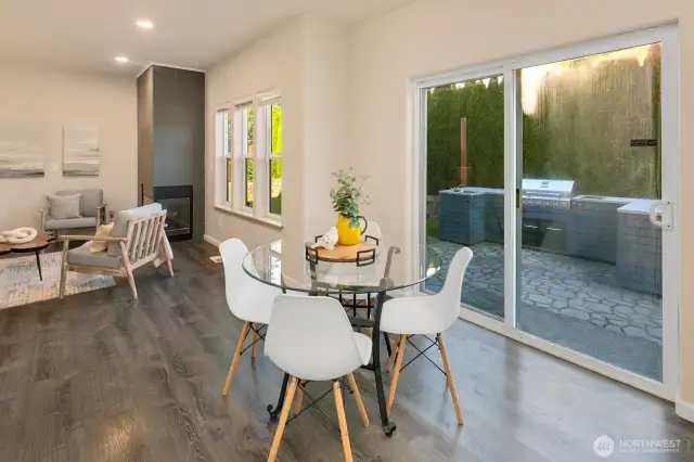 Nook opens up to sliding glass door and back yard patio with BBQ and firepit area