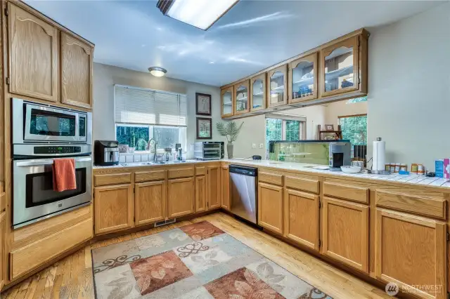 Stainless appliances and hardwood flooring in the kitchen.