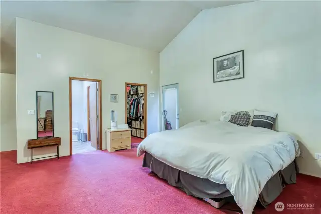Looking back at the bathroom, walk in closet and door to a private deck.