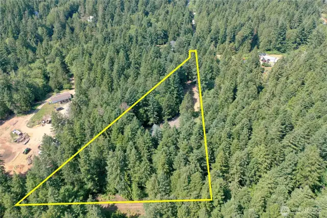 Approximate property lines showing home on nearly 2.5 acres.  Driveway enters from the top right.