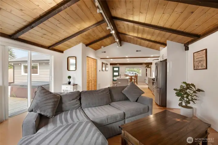 Move seamlessly into the family room where the vaulted ceiling, accented by Douglas Fir, combine to create an airy yet cozy environment.  This space is also nice because it can accommodate a large couch like the one pictured here.