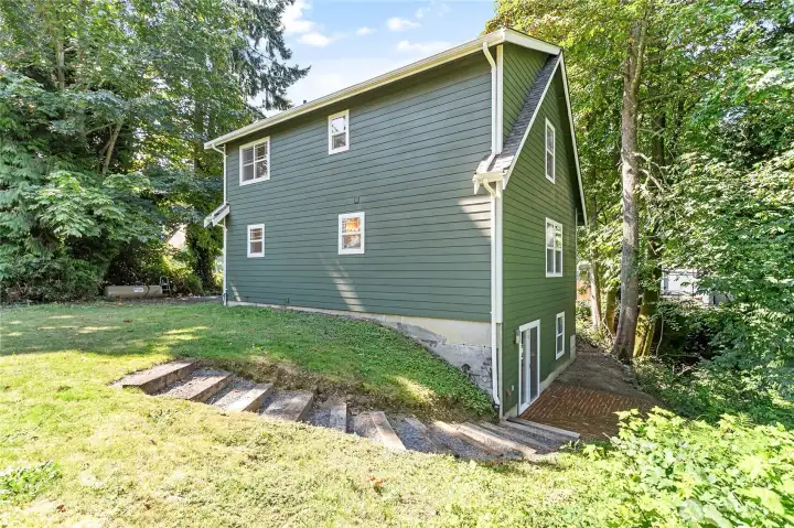 Around the backside of the house in the private yard.