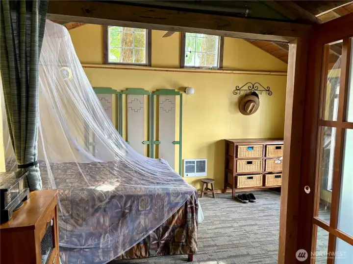 Bedroom with deck access and lake views.