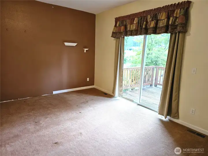 Main bedroom with sliding door out to deck overlooking golf course