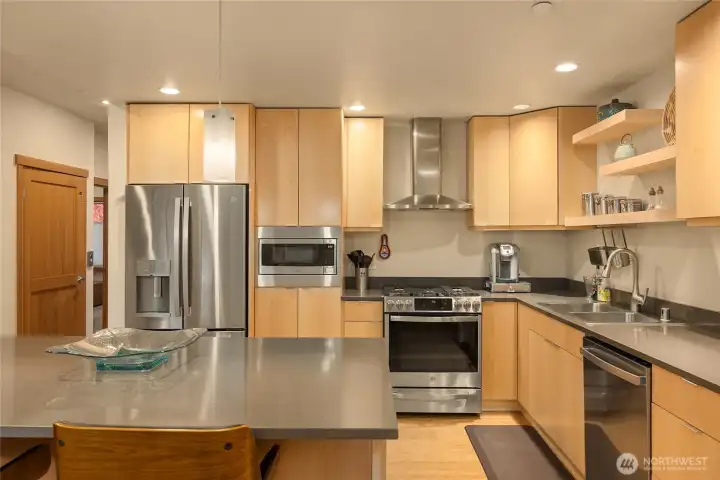 What a great kitchen! New countertops, new appliances, new cabinet fronts of natural wood, with open shelving added to showcase your special pieces.