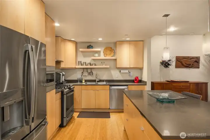 The updated kitchen has a large prep counter with seating for guests to join you as you entertain. The open floor plan makes every room feel light and bright.