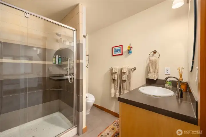 A look at the shower and bath accessible from the bedroom and hallway.