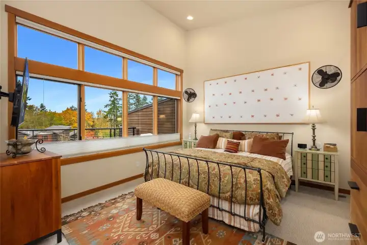 The dreamy primary suit enjoys large windows, vaulted ceilings, a walk in closet and adjoining spa like bath.