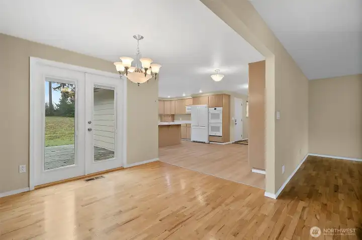 A view from the dining room towards the kitchen.  The french doors lead you to a good size deck area.