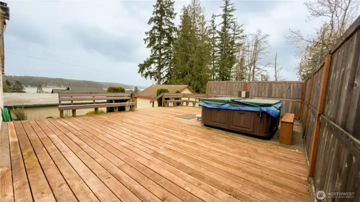 Side porch with benches and hot tub.