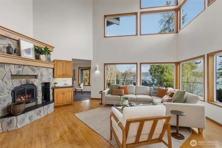 Family room with soaring ceilings, wet bar and fireplace.